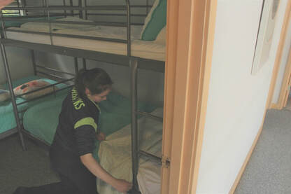 Cleaning technician making up a room