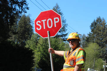Certified flagger holding a stop paddle